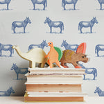 illustrated blue donkey on white background wallpaper pattern behind stack of books peel and stick