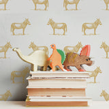 illustrated marigold yellow orange donkey on white background wallpaper pattern behind stack of books peel and stick