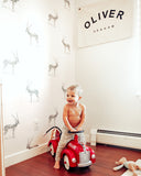 illustrated grey antelope pattern on white background Removable Peel and stick wallpaper in kids room with child playing